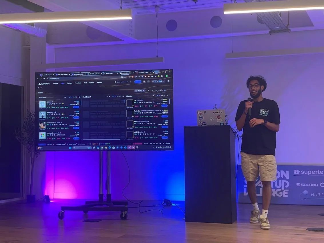 Sami presenting on stage at a hackathon